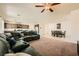 Spacious living room features a large leather sectional sofa, open layout to the kitchen, and comfortable carpet at 5908 Beluga Bay St, North Las Vegas, NV 89081