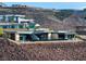 Aerial view of a modern home on a hillside with stunning views at 705 Dragon Peak Dr, Henderson, NV 89012