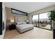 Bright bedroom with light wood floors, large window, and ensuite bathroom access at 705 Dragon Peak Dr, Henderson, NV 89012