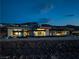 Contemporary home at dusk with city lights in the background at 705 Dragon Peak Dr, Henderson, NV 89012