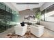 Modern home office with glass wine cellar and stylish furnishings at 705 Dragon Peak Dr, Henderson, NV 89012