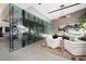 Modern office features glass-enclosed wine cellar and stylish furniture at 705 Dragon Peak Dr, Henderson, NV 89012