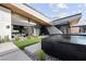Modern backyard oasis with a sleek pool and grassy area at 705 Dragon Peak Dr, Henderson, NV 89012
