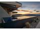Infinity pool with sunset views and modern landscaping at 705 Dragon Peak Dr, Henderson, NV 89012