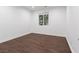 Spacious bedroom with dark wood flooring and large window at 7840 Thunder Echo St, Las Vegas, NV 89131