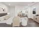 Bright bedroom with a king bed and wood floors leading into an additional seating area at 7840 Thunder Echo St, Las Vegas, NV 89131