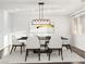 Bright dining room with modern light fixture, table, and seating at 7840 Thunder Echo St, Las Vegas, NV 89131