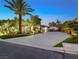 Landscaped front yard with palm trees and driveway at 7840 Thunder Echo St, Las Vegas, NV 89131