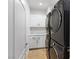 Bright laundry room with white cabinets and modern washer and dryer at 7840 Thunder Echo St, Las Vegas, NV 89131