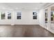 Living room with hardwood floors, multiple windows, and French doors at 7840 Thunder Echo St, Las Vegas, NV 89131