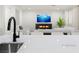 Bright living room featuring a modern fireplace, white furniture, and a large television at 7840 Thunder Echo St, Las Vegas, NV 89131