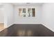 Bright living room with dark hardwood floors and large windows at 7840 Thunder Echo St, Las Vegas, NV 89131
