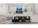 Bright living room featuring a modern fireplace and white sofas at 7840 Thunder Echo St, Las Vegas, NV 89131