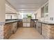 Outdoor kitchen with stainless steel appliances and stone countertops at 7840 Thunder Echo St, Las Vegas, NV 89131