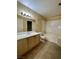 Bathroom showcasing a tub/shower combo and light wood vanity and tile flooring at 8441 Blue Island Ave, Las Vegas, NV 89129