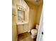 Small powder room with light wood vanity and a mirrored wall at 8441 Blue Island Ave, Las Vegas, NV 89129