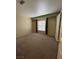 Neutral carpeted bedroom featuring a window with privacy blinds and neutral toned walls at 8441 Blue Island Ave, Las Vegas, NV 89129