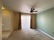 Dining area with a ceiling fan, neutral walls, sliding doors with blinds, and carpet providing a cozy feel at 8441 Blue Island Ave, Las Vegas, NV 89129