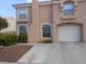 Charming two-story home featuring a stucco facade, arched windows, a two-car garage, and a well-maintained front yard at 8441 Blue Island Ave, Las Vegas, NV 89129