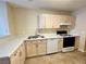 Functional kitchen featuring light wood cabinets, white countertops, modern appliances, and neutral tile floors at 8441 Blue Island Ave, Las Vegas, NV 89129