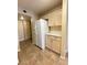 Spacious kitchen featuring light wood cabinets, white appliances, neutral tile floors, and ample storage space at 8441 Blue Island Ave, Las Vegas, NV 89129