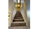 Carpeted staircase with white banister ascends to the upper level of the home at 8441 Blue Island Ave, Las Vegas, NV 89129