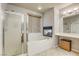 Relaxing bathroom with soaking tub, walk-in shower, and fireplace at 869 Ashford Way, Henderson, NV 89015