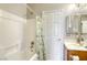Clean bathroom with a shower/tub combo and wooden vanity at 869 Ashford Way, Henderson, NV 89015