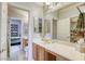 Bathroom with double sinks and a view into bedroom at 869 Ashford Way, Henderson, NV 89015
