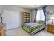 Bedroom with a striped comforter and built-in shelving at 869 Ashford Way, Henderson, NV 89015