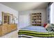 Bedroom with a striped comforter and built-in shelving at 869 Ashford Way, Henderson, NV 89015
