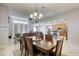 Elegant dining room with a large wooden table and chandelier at 869 Ashford Way, Henderson, NV 89015