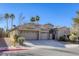 Two-story house with a three-car garage and desert landscaping at 869 Ashford Way, Henderson, NV 89015