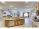 Open kitchen with large island, hardwood cabinets and stainless steel appliances at 869 Ashford Way, Henderson, NV 89015