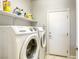 Laundry room with washer, dryer, and ample shelving at 869 Ashford Way, Henderson, NV 89015