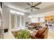 Bright living room with access to backyard, leather furniture, and ceiling fan at 869 Ashford Way, Henderson, NV 89015