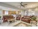 Spacious living room featuring leather furniture and a cozy fireplace at 869 Ashford Way, Henderson, NV 89015