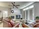 Living room with fireplace, large windows, and comfortable leather furniture at 869 Ashford Way, Henderson, NV 89015