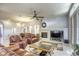 Living room with a fireplace, leather sofas, and large TV at 869 Ashford Way, Henderson, NV 89015