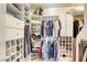 Large walk-in closet with custom shelving and drawers at 869 Ashford Way, Henderson, NV 89015