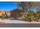 House exterior with a two-car garage and palm trees at 1327 Beehive Ln, Mesquite, NV 89034