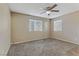 Spacious bedroom with ceiling fan and large windows at 201 Mission Laguna Ln # 105, Las Vegas, NV 89107