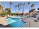 Community pool with ample deck space and lounge chairs at 201 Mission Laguna Ln # 105, Las Vegas, NV 89107