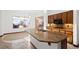 Granite counters highlight this kitchen and island with stainless steel sink and wood cabinetry at 23 Feather Sound Dr, Henderson, NV 89052