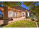 Outdoor patio with sliding glass doors and a well-maintained lawn at 23 Feather Sound Dr, Henderson, NV 89052