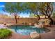 Backyard pool featuring rock accents, mature landscaping, and a tranquil water feature at 23 Feather Sound Dr, Henderson, NV 89052