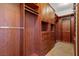 Spacious walk-in closet with custom wood organizers, shelves and drawers at 23 Feather Sound Dr, Henderson, NV 89052