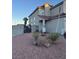 View of the front yard with yucca plants and desert landscaping, featuring a two-story home at 3338 Commendation Dr, Las Vegas, NV 89117