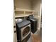 Laundry room with washer, dryer, and shelving units at 3338 Commendation Dr, Las Vegas, NV 89117