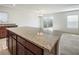 Granite kitchen island with seating space overlooking the living room at 343 Burgos Ave, Las Vegas, NV 89030